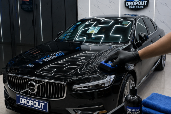 Professional ceramic coating application on a luxury sedan with high-gloss finish and advanced paint protection at premium detailing studio